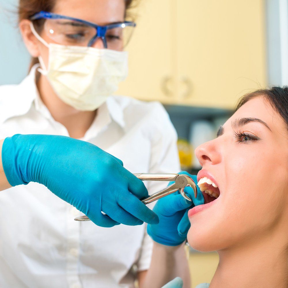 Extracting Woman Tooth — Sarasota, FL — Sterling Dental