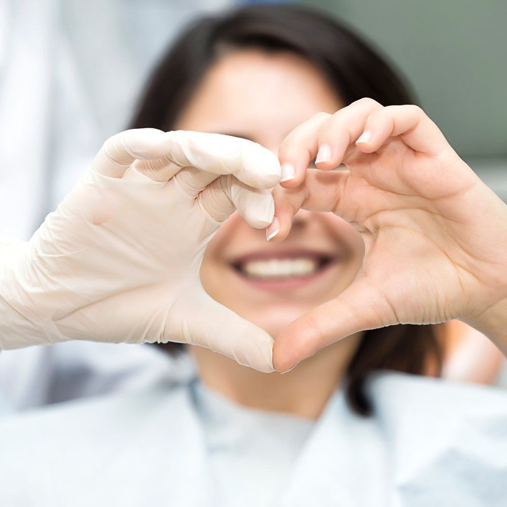 Dentist And Patient Heart Shape Using Hand — Sarasota, FL — Sterling Dental