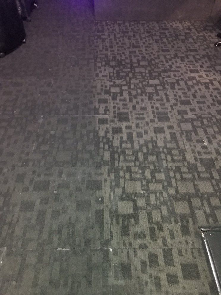 A carpeted floor with a pattern of squares on it