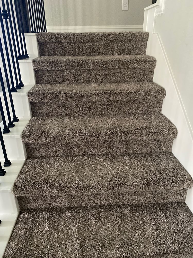 A set of stairs with a carpeted staircase in a house.
