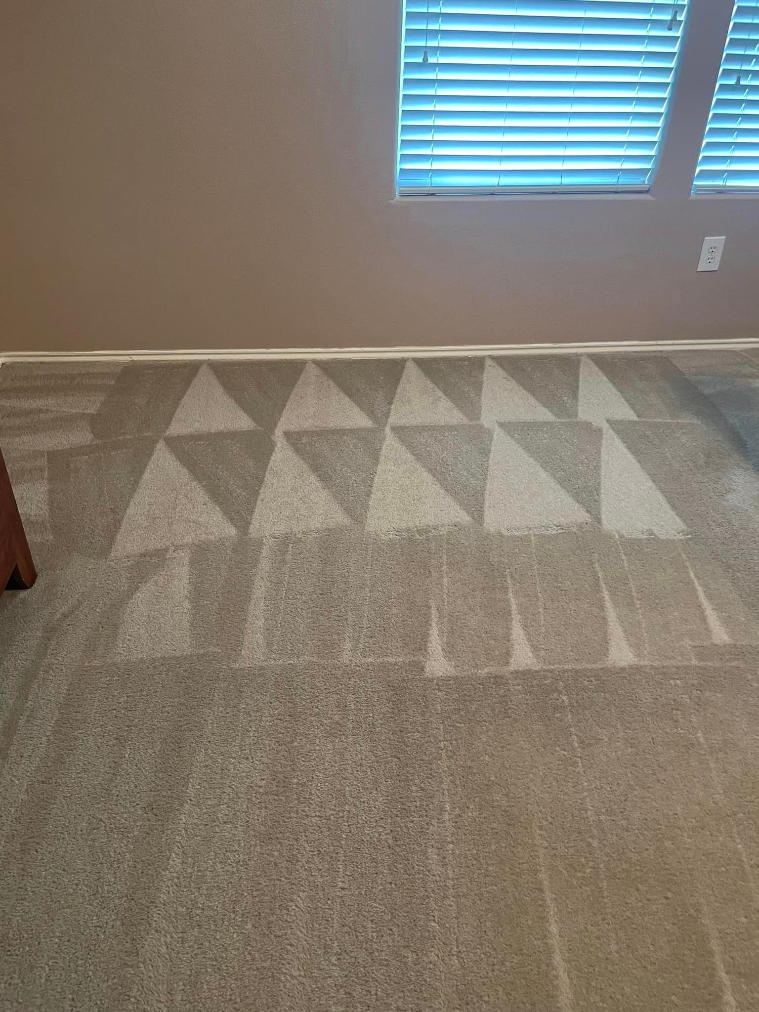 A carpet in a living room with a pattern of triangles on it.