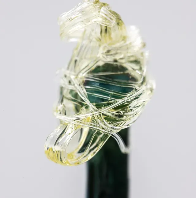 A close up of a bottle with a ring on it