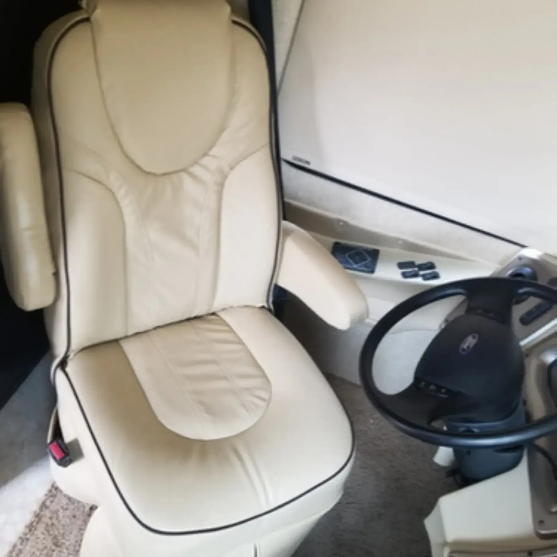 Piece By Piece of Houston LLC
 - A white leather chair sits next to a steering wheel