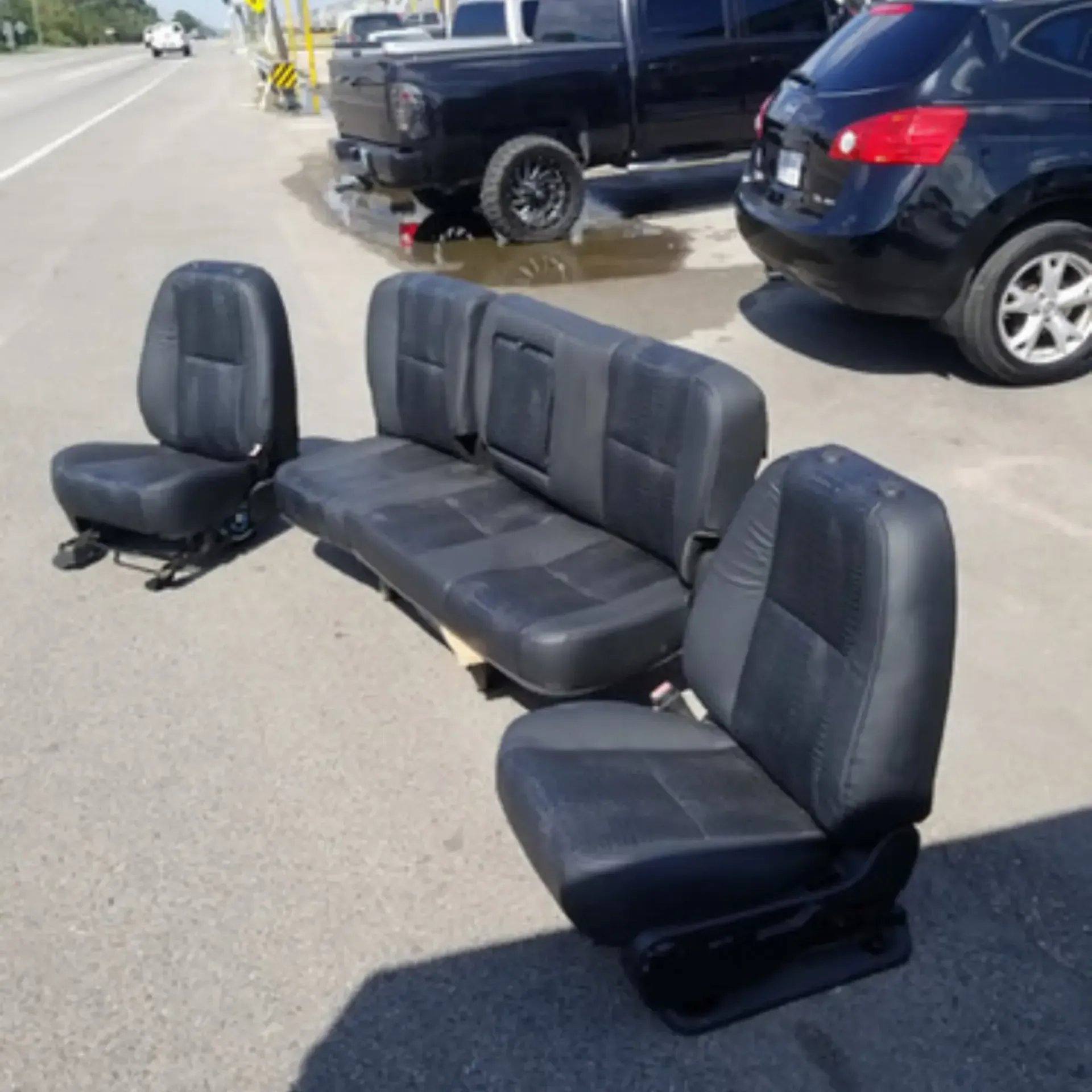 Piece By Piece of Houston LLC
- A row of black car seats are sitting on the side of the road
