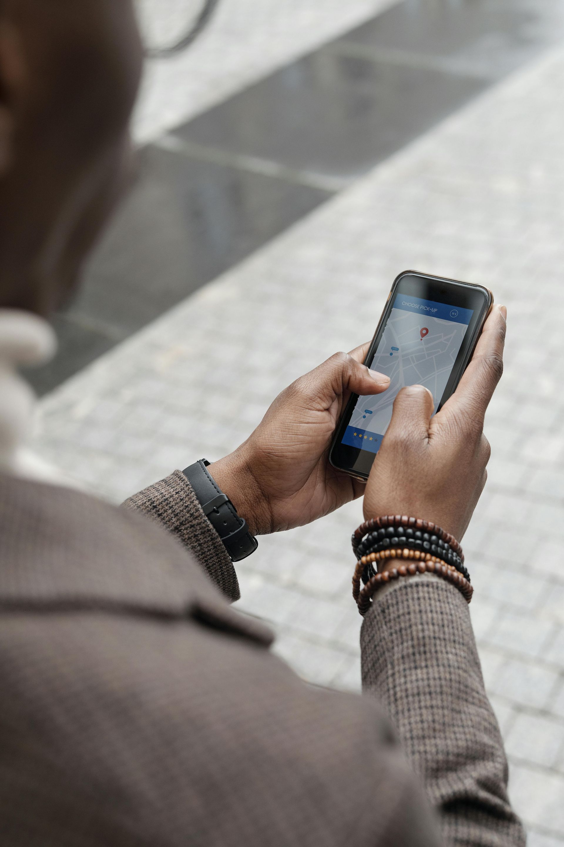 A man is holding a cell phone in his hands.