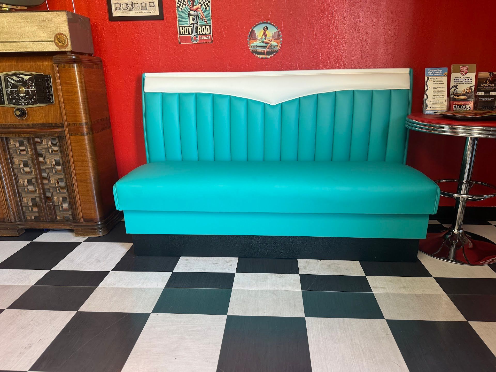 Teal and White Diner Booth Against a Red Wall with a Jukebox | Greasers Automotive