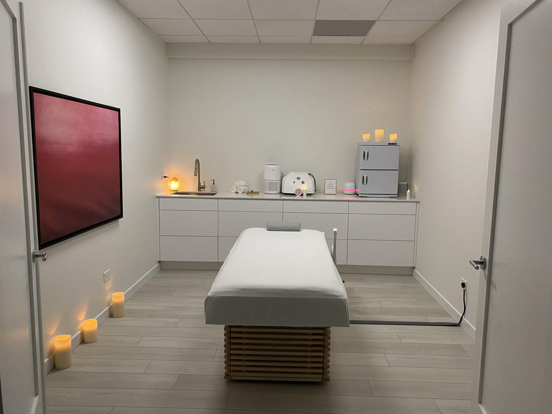 There is a massage table in the middle of the room.