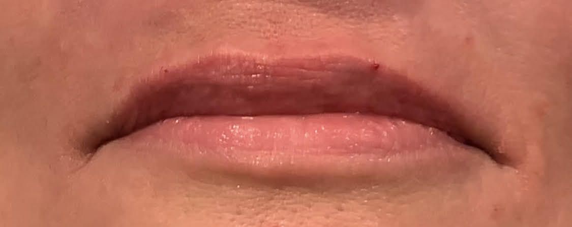A close up of a woman 's lips with red lipstick.