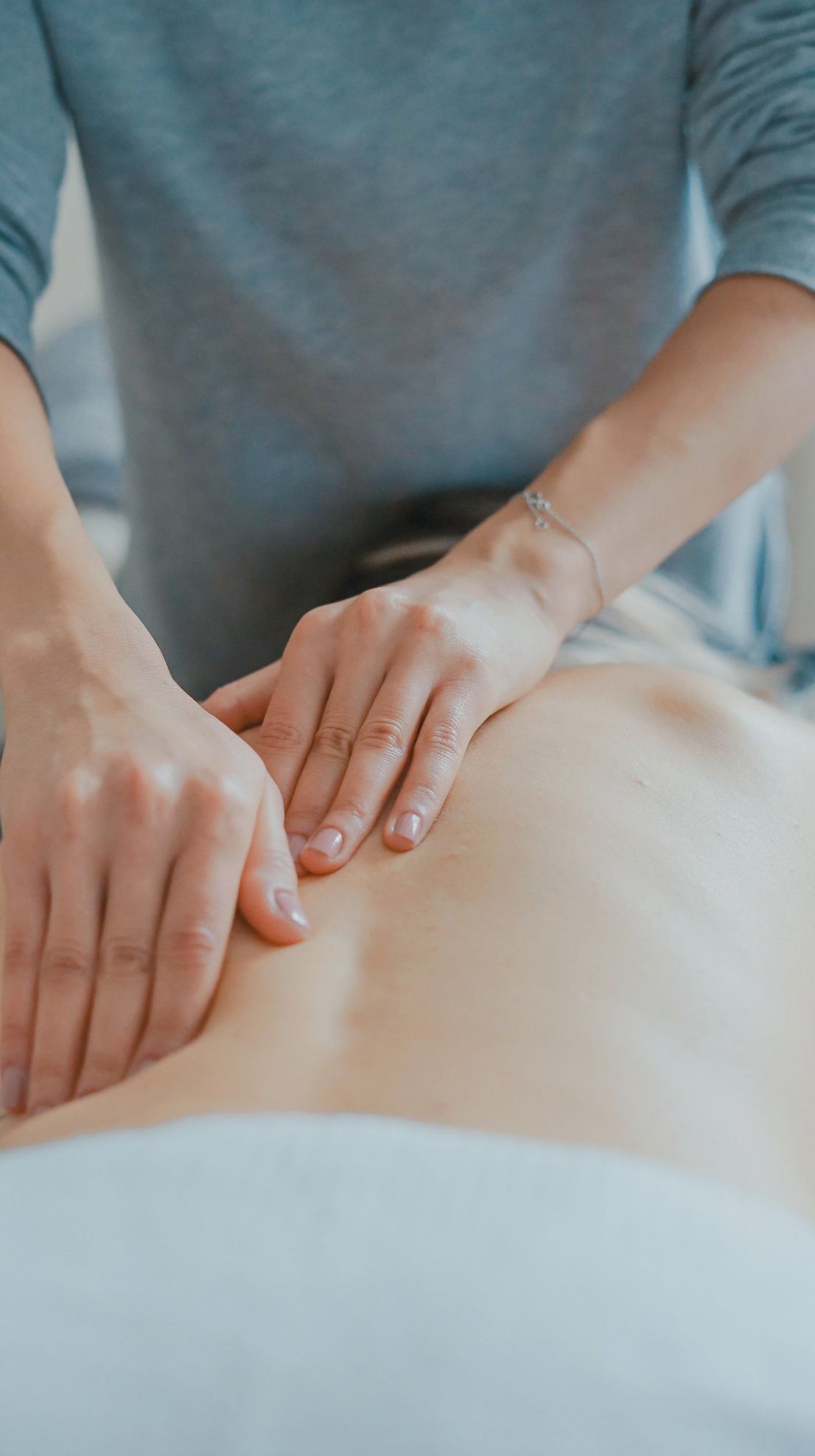 A person is giving a massage to another person.