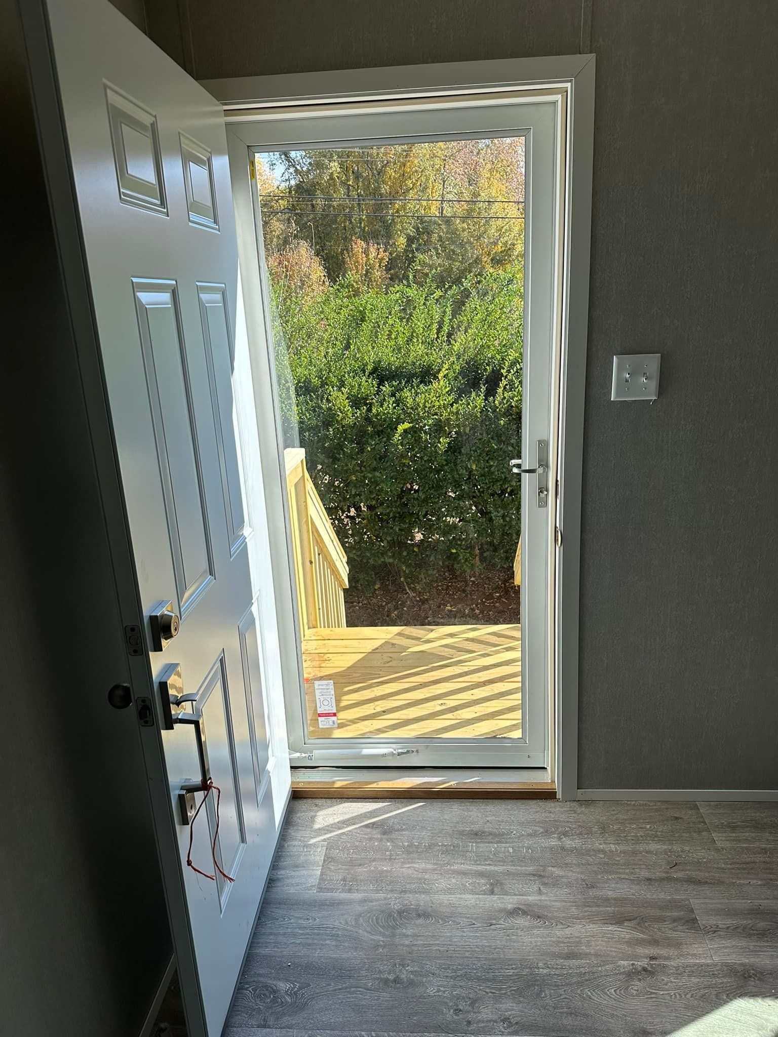 A white door with a glass door is open in a room.