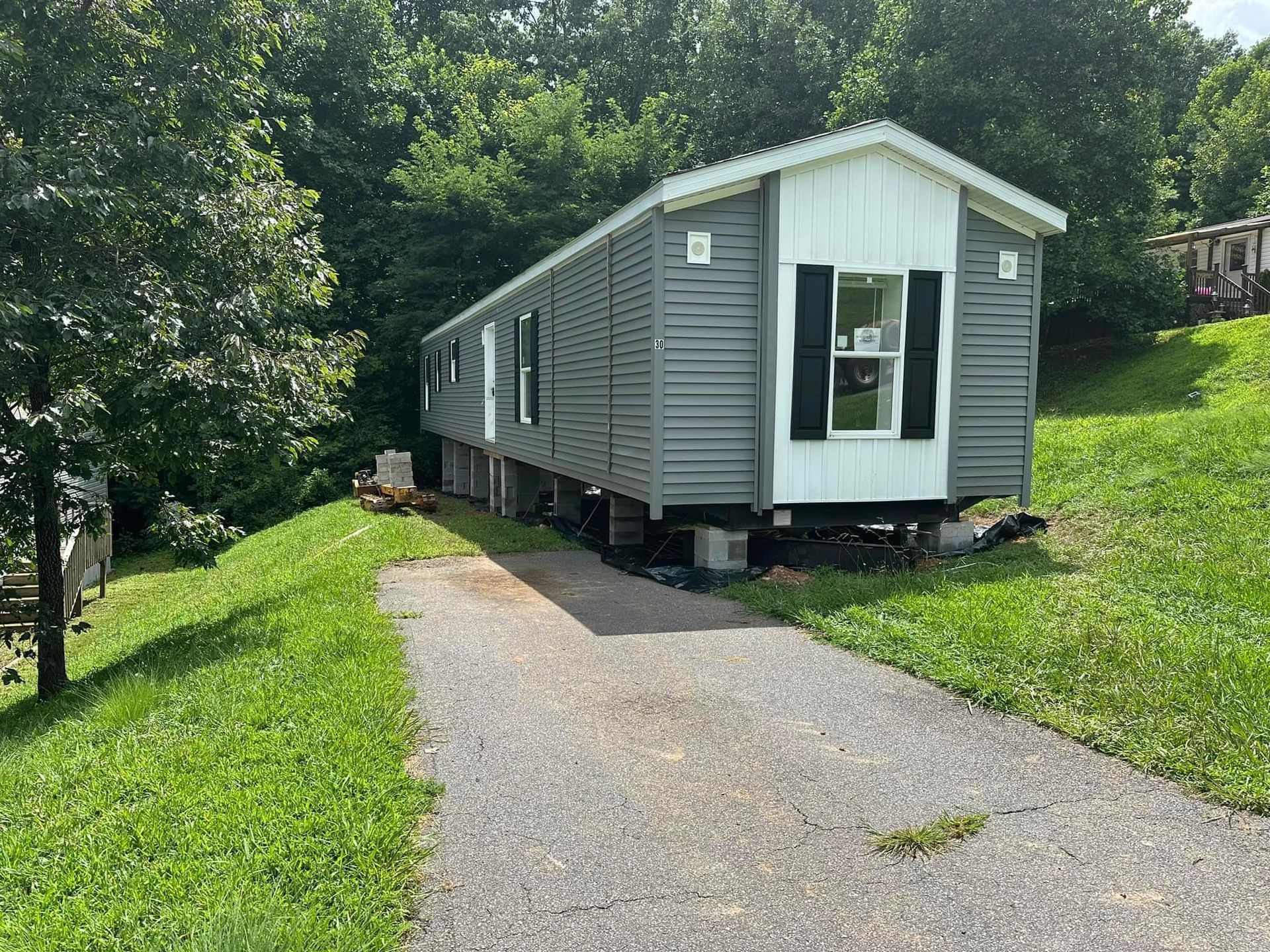 A mobile home is parked on the side of a dirt road.