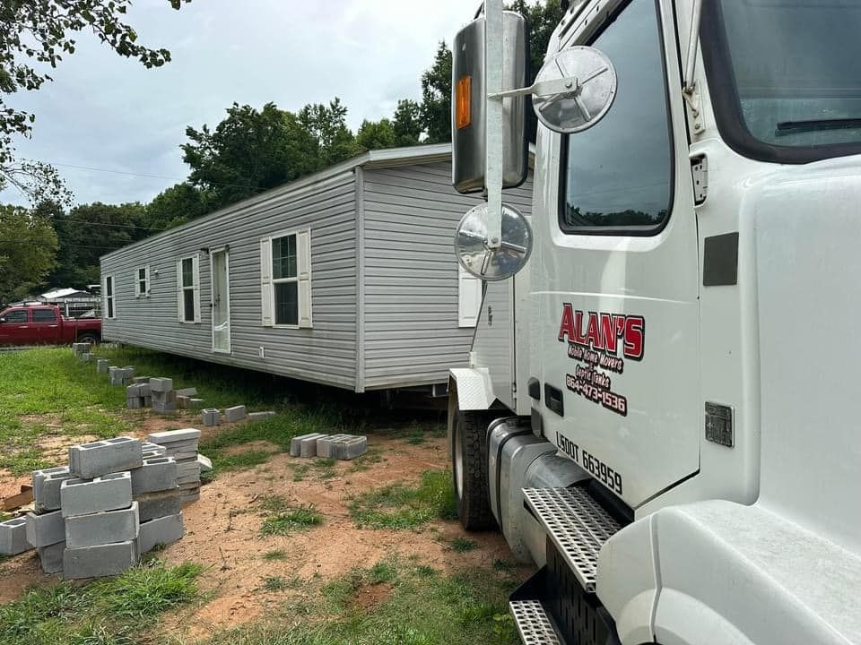 A white truck with alan 's written on the side