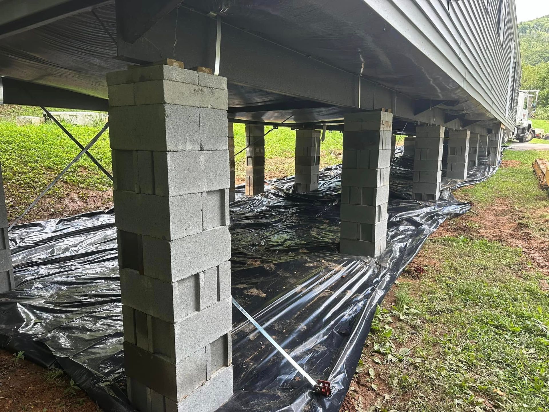 The foundation of a house is being built with concrete blocks.