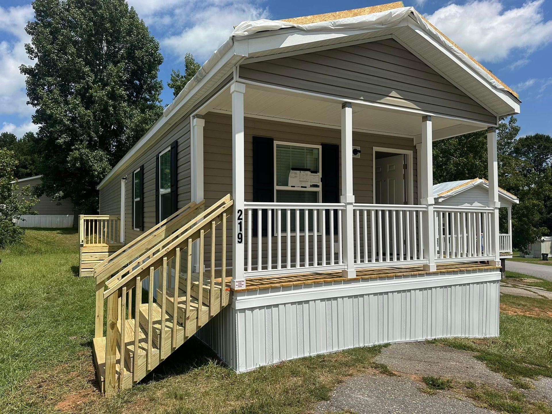 A mobile home with a porch and stairs