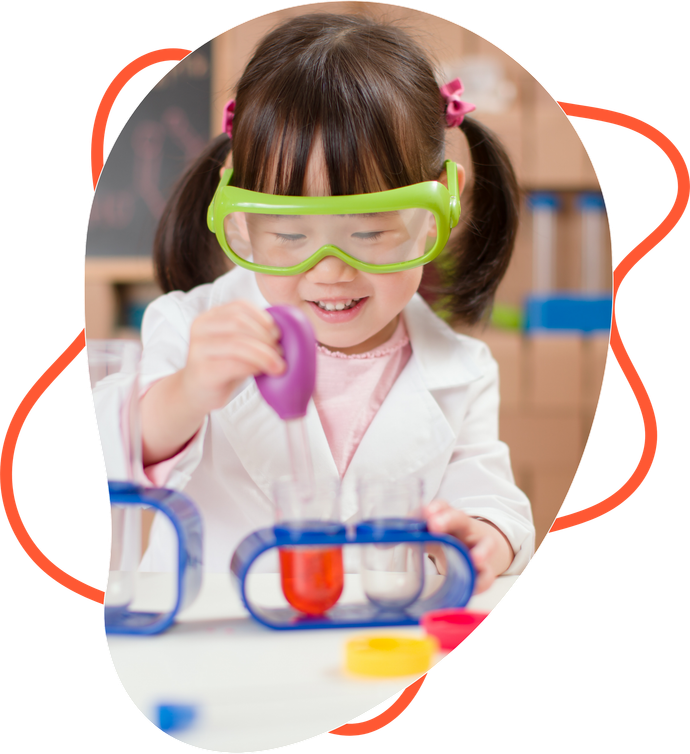 A little girl wearing goggles and a lab coat is playing with test tubes