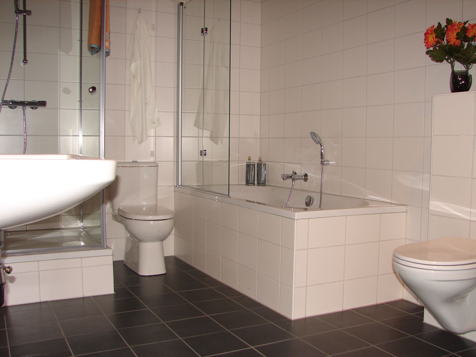 A bathroom with a sink toilet and bathtub
