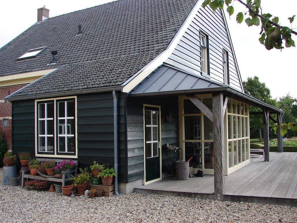 A black and white house with a large porch