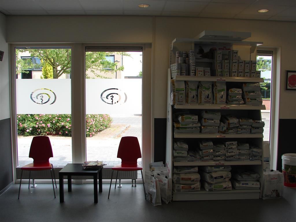 A waiting room with a shelf full of dog food