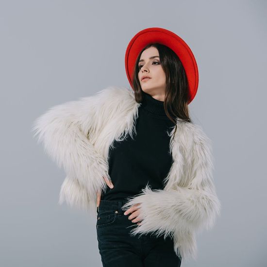 Woman Wearing Coat and Red Hat — Bayonne, NJ — Famous Furs Ltd.
