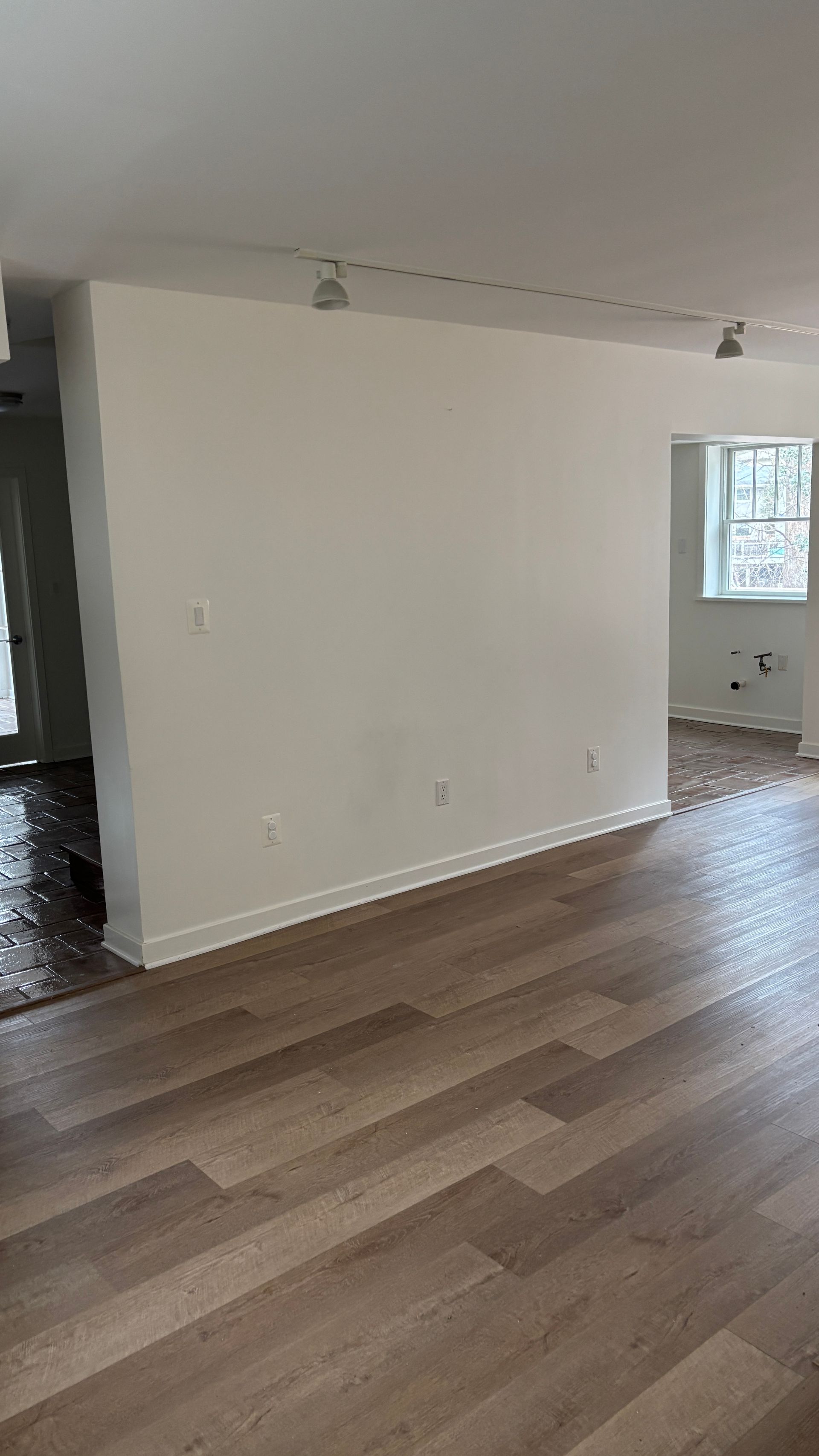 Interior of a yellow shed with shelves, propane tanks, a lawnmower, and other stored items.