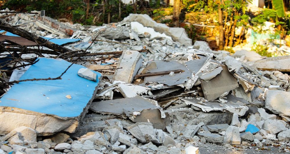 Pile of rubble; blue object visible, debris from a collapsed building.