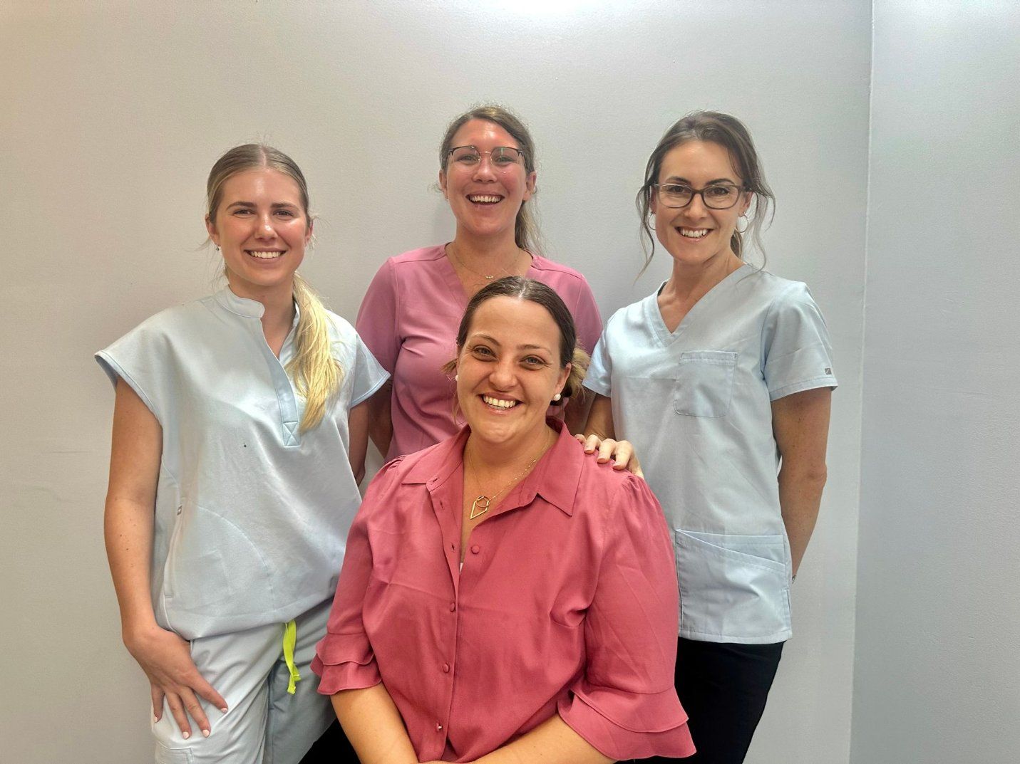 A Group of Nurses Are Posing for A Picture Together and Smiling — Diamond Beach Veterinary Clinic In Diamond Beach, NSW
