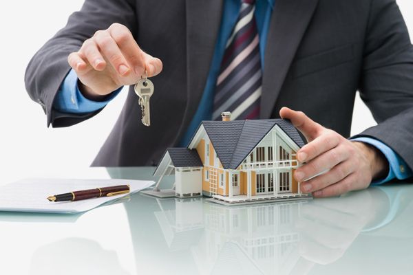 Property expert handing the keys of the house to the customer