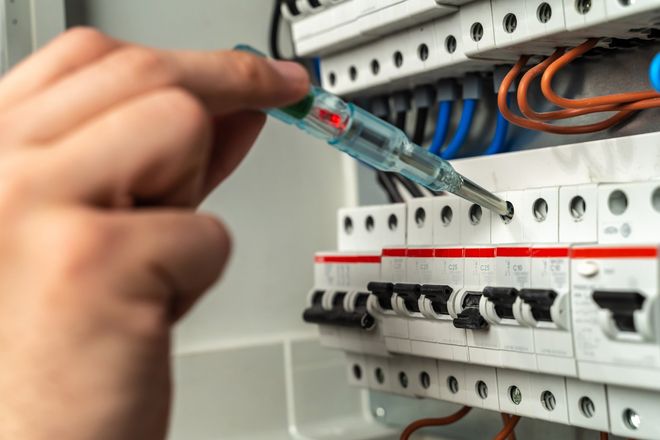 Electrician Testing Fuse Box — Central Coast, NSW — Adaz Electrical