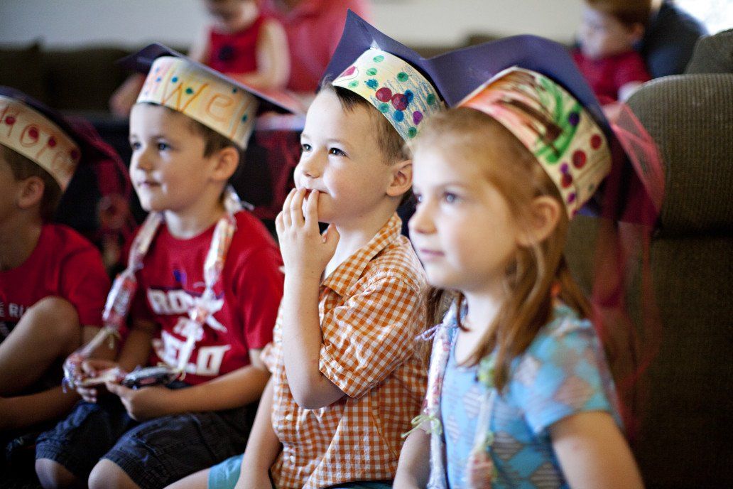 Toddlers sit and listen during school activity
