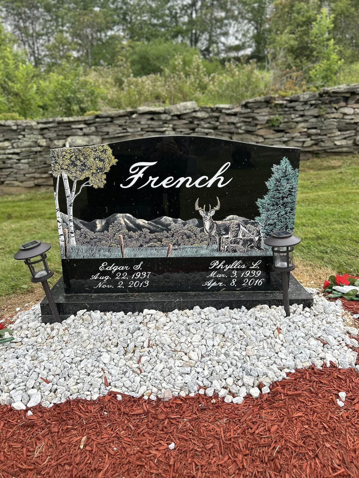 Black granite headstone engraved with the last name 