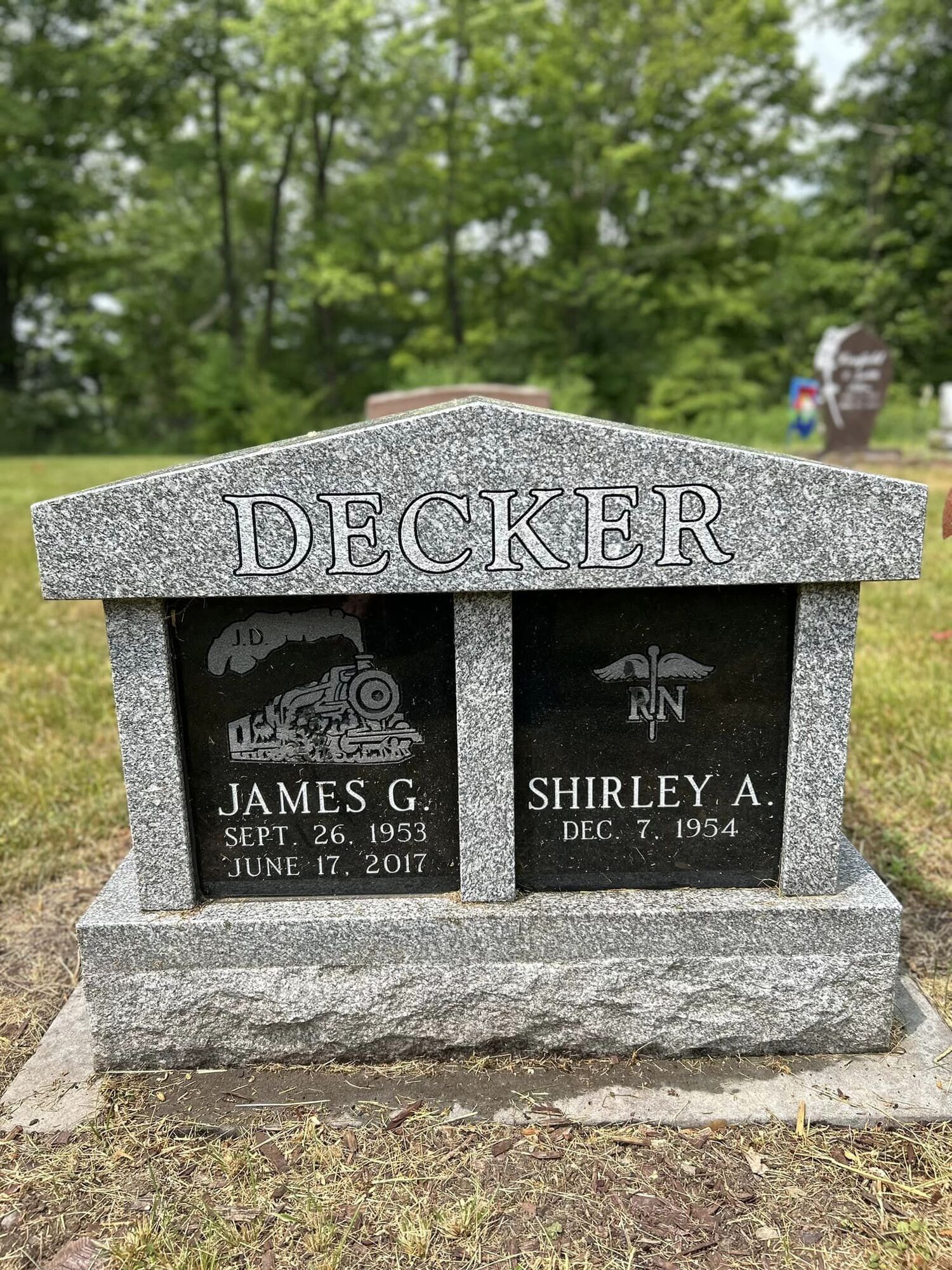 Gray granite headstone engraved with 