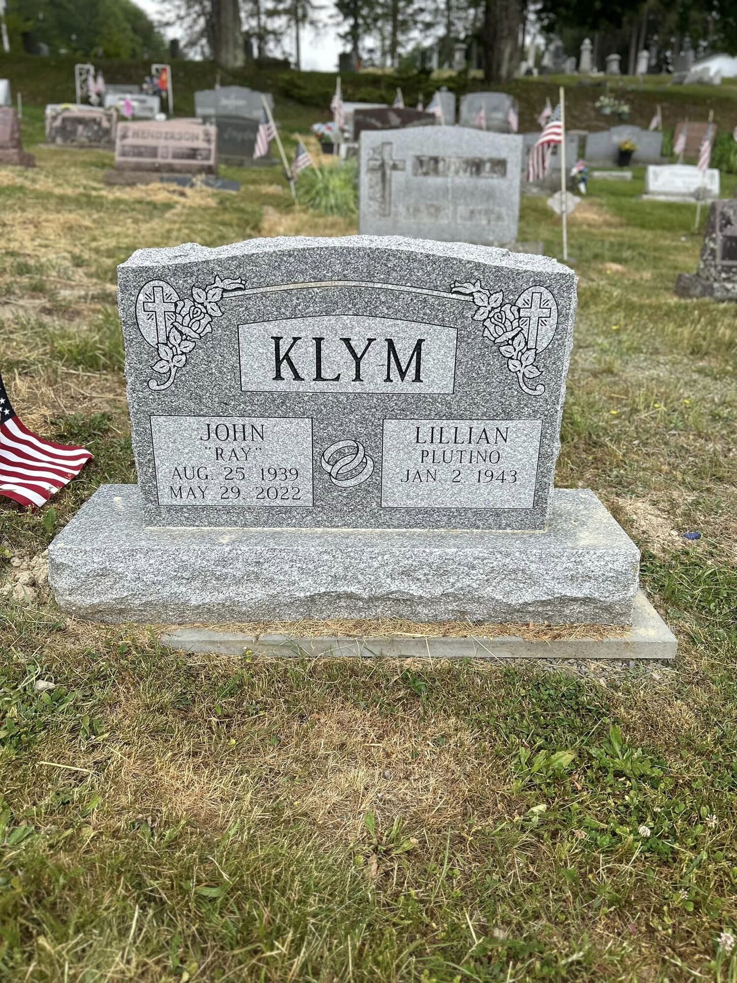 Gravestone of John and Lillian Klym in a cemetery.