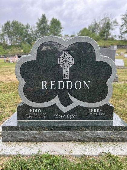 Headstone for Eddy and Terry Reddon, shaped like a shamrock, with Celtic cross detail.