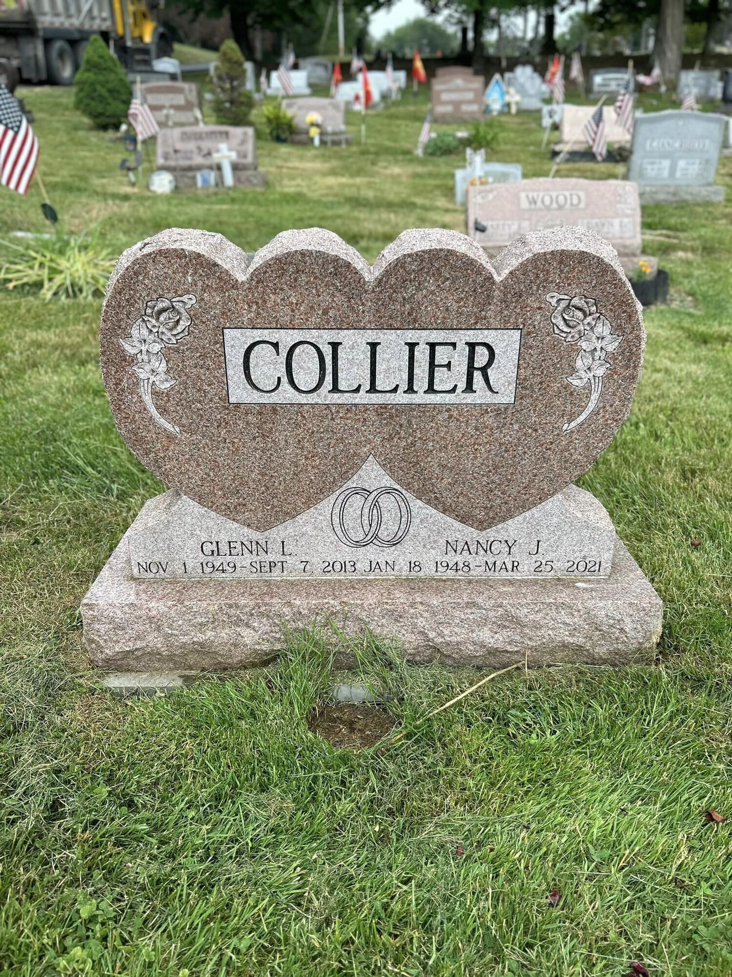 A granite tombstone in a cemetery, bearing the family name 