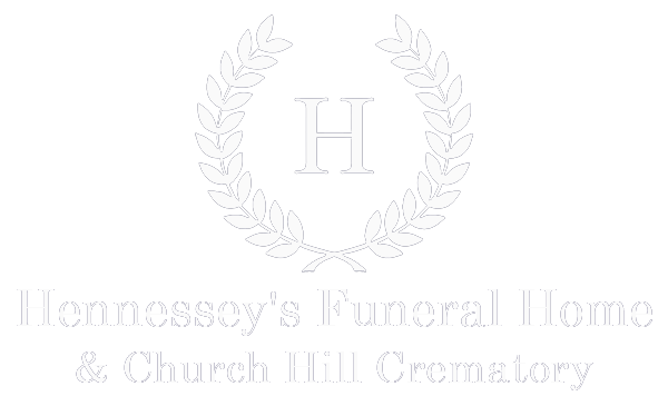 Logo of Hennessy's Funeral Home & Church Hill Crematory: wreath around an 