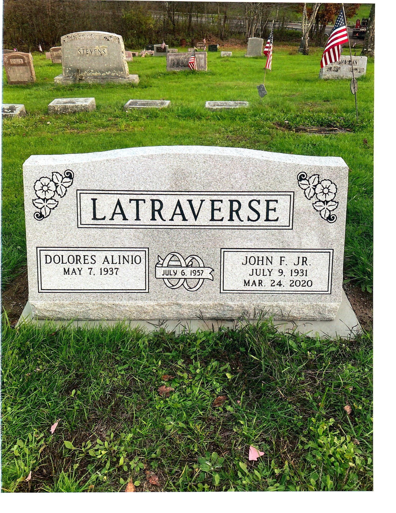 Headstone in a cemetery with the surname LATRAVERSE. Graves of Dolores and John Jr. are marked.