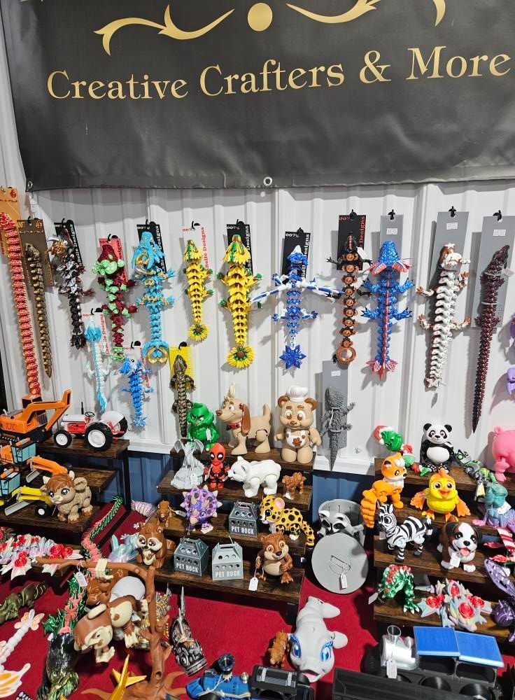 A bunch of toys are displayed in front of a sign that says creative crafters & more