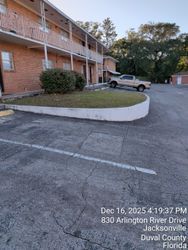 Apartment building exterior, beige truck parked. Jacksonville, Florida.