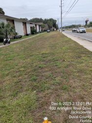 Grassy median next to a road and a low-rise apartment building; Jacksonville, Florida. Date and address at the bottom.