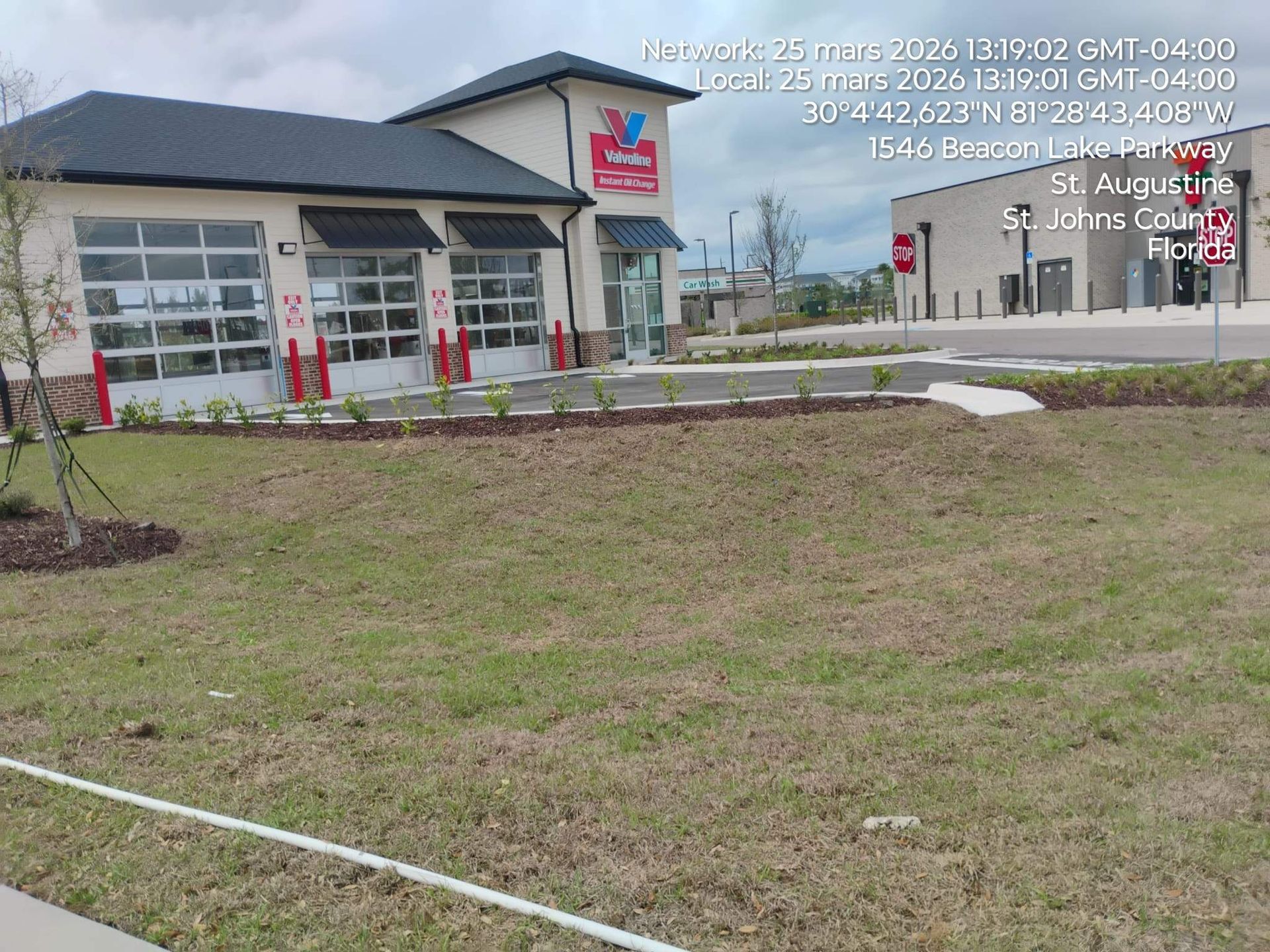 Culver’s restaurant exterior with sign, parking lot, and grassy foreground under a cloudy sky