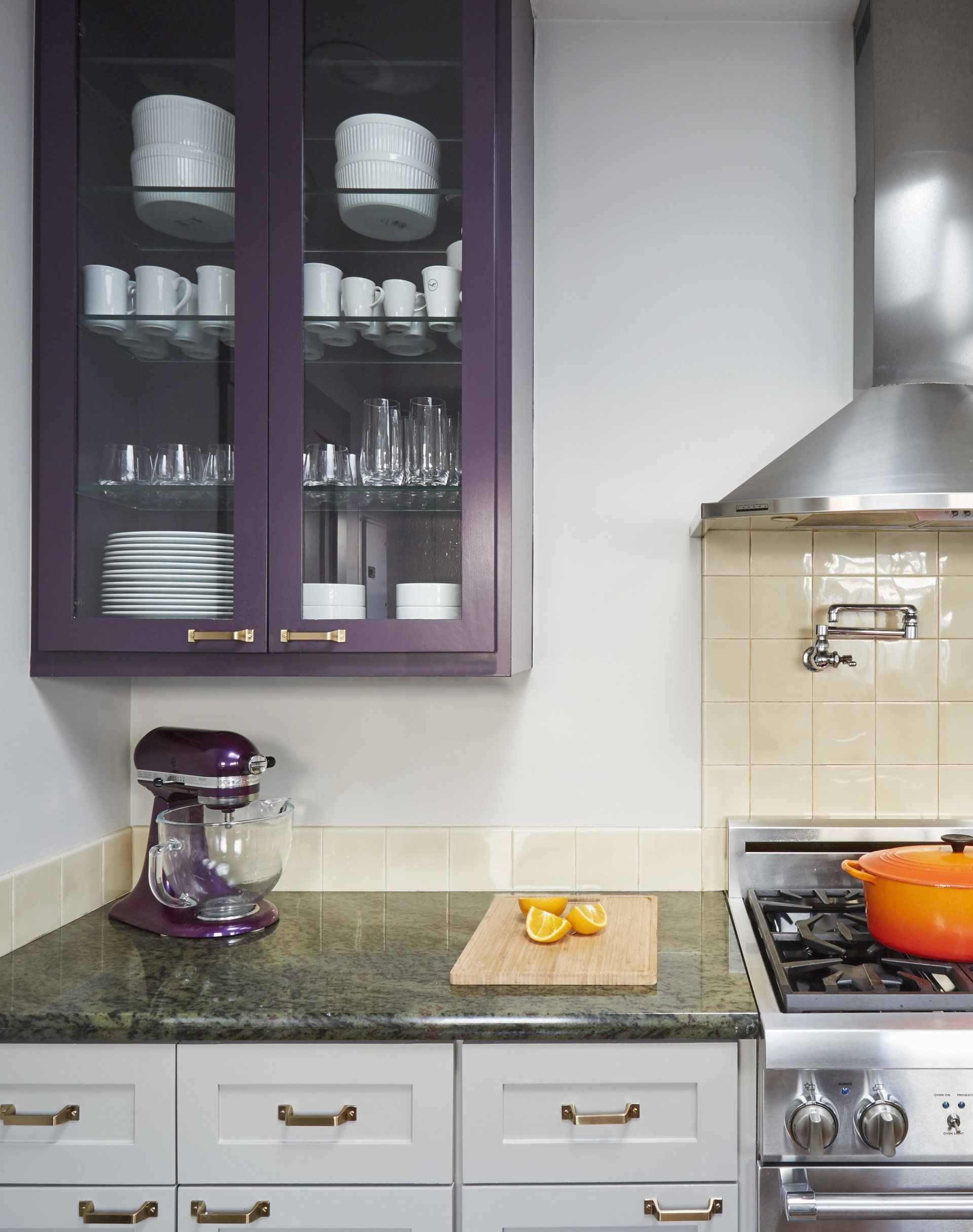 A kitchen with purple cabinets and white cabinets