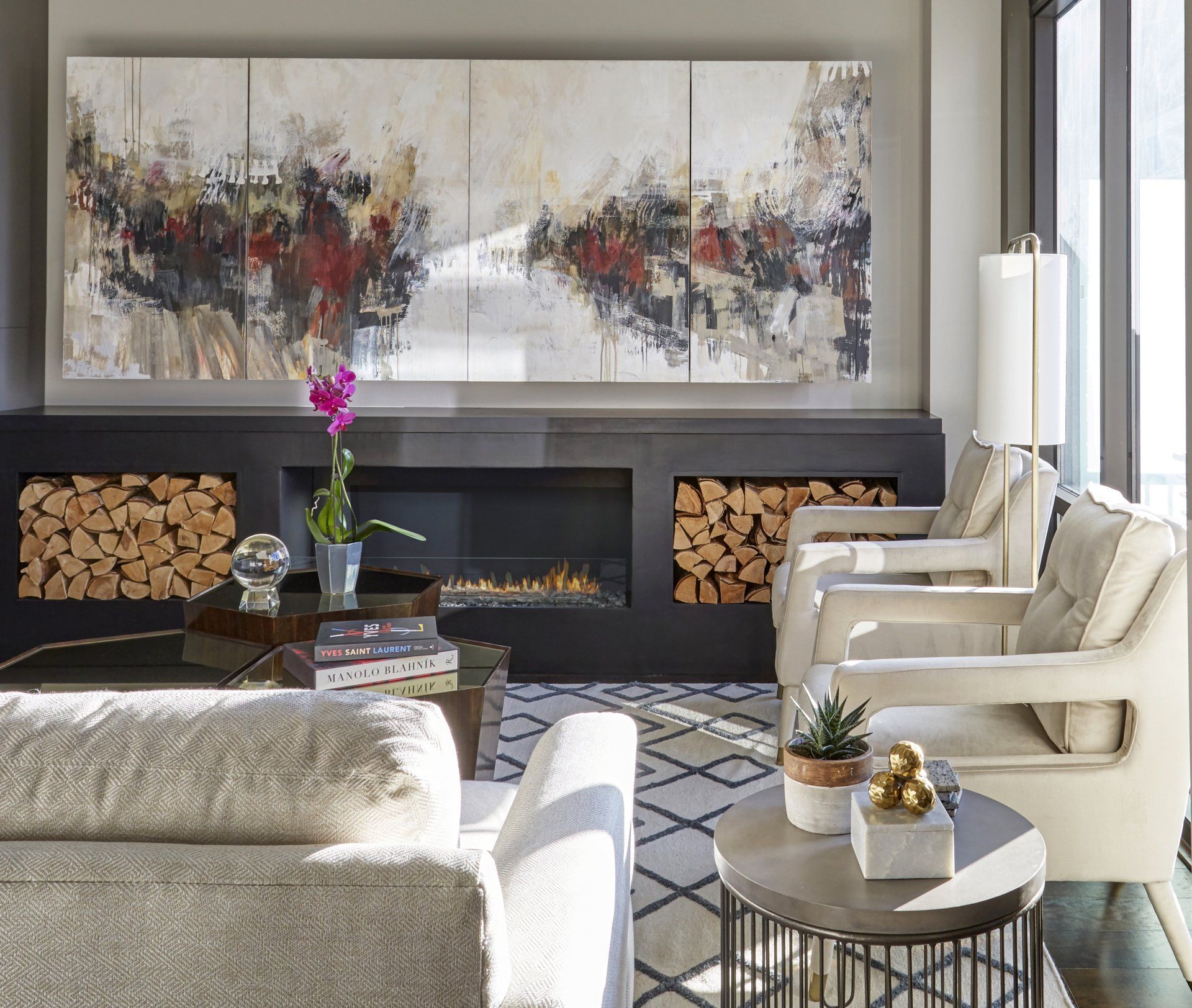 A living room with a fireplace and a painting on the wall