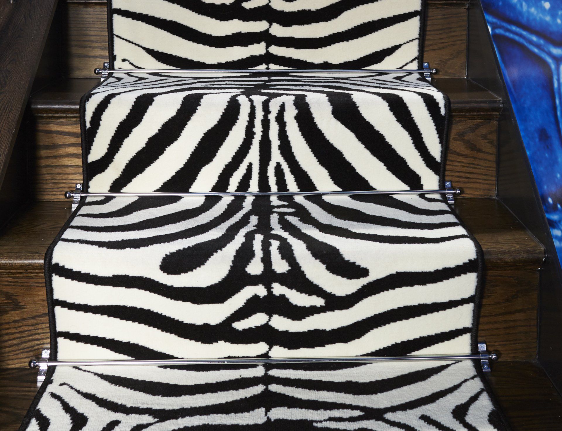 A staircase with a zebra print rug on it