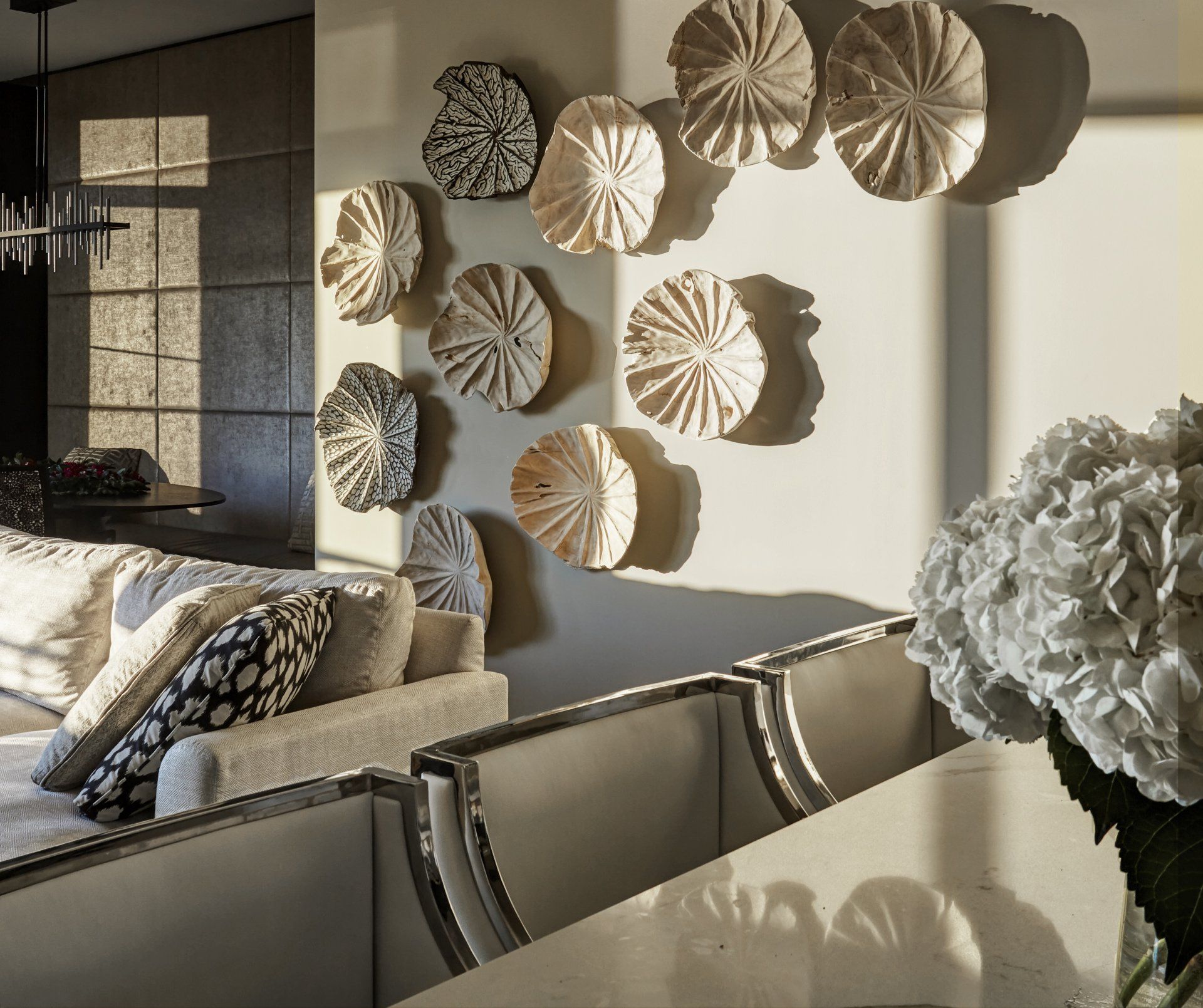 A living room with a couch and plates on the wall