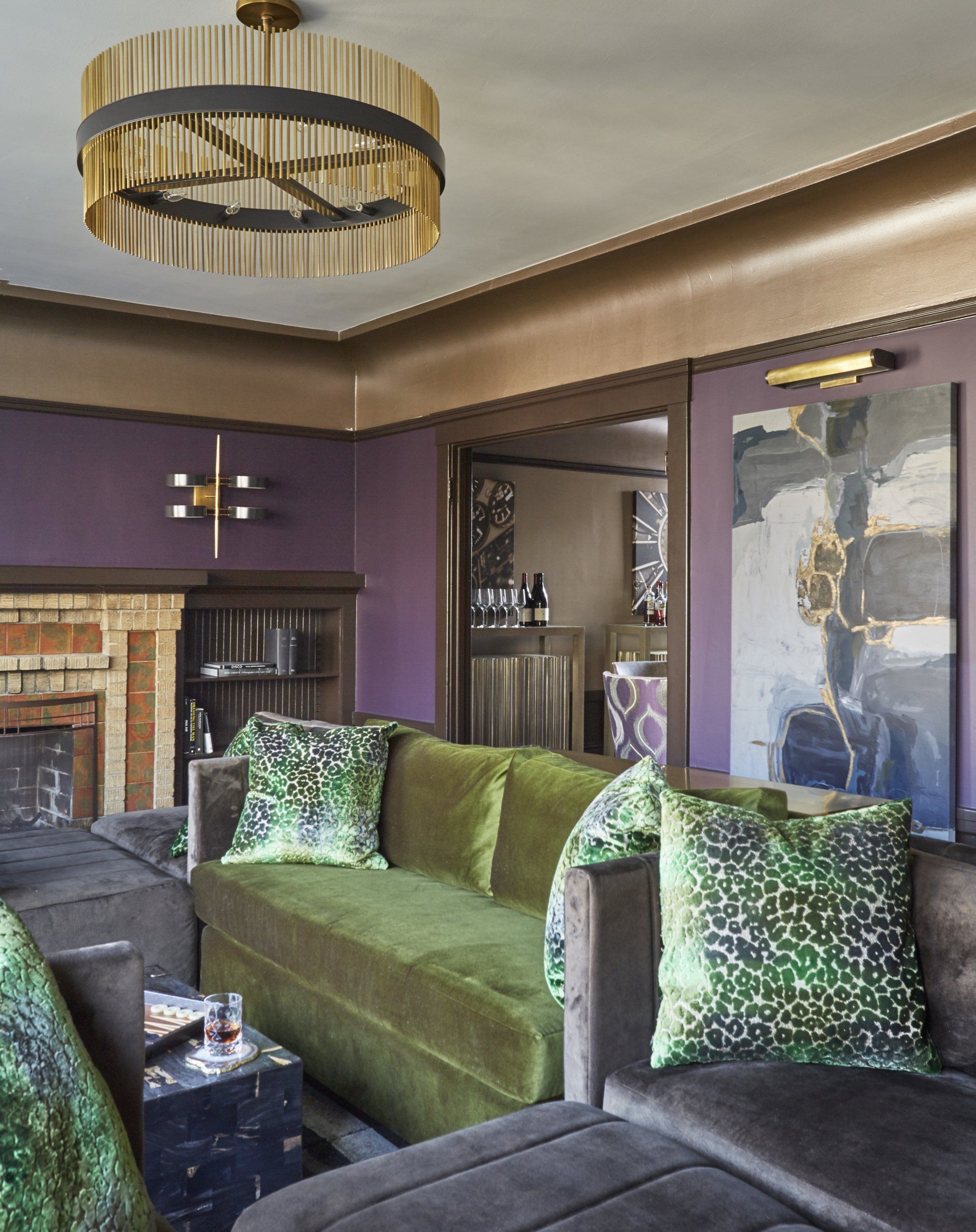 A living room with a green couch and purple walls