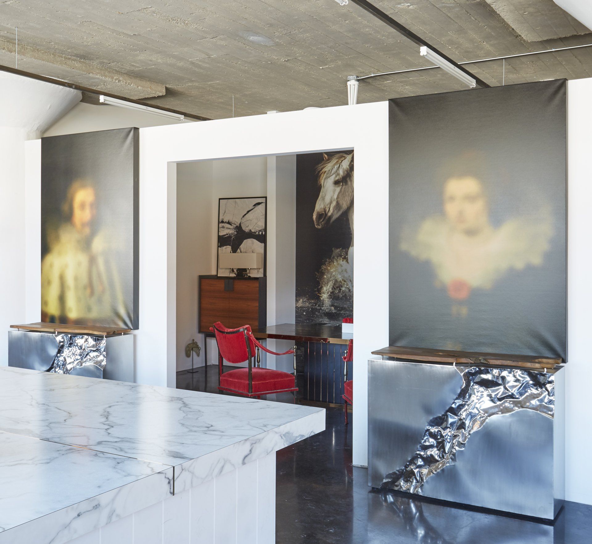 A room with a marble counter top and a painting on the wall