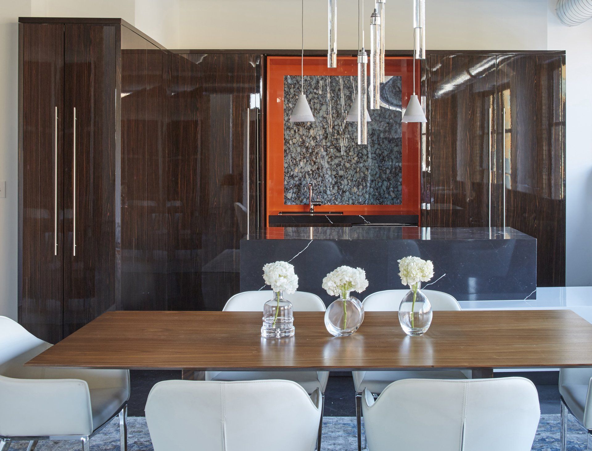 A dining room table with vases of flowers on it