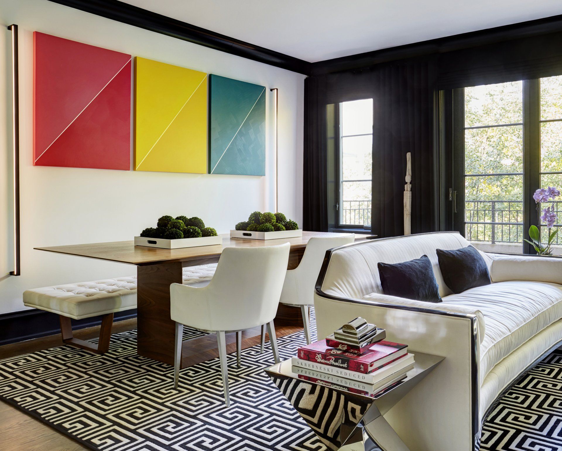 A living room with a couch a table and chairs