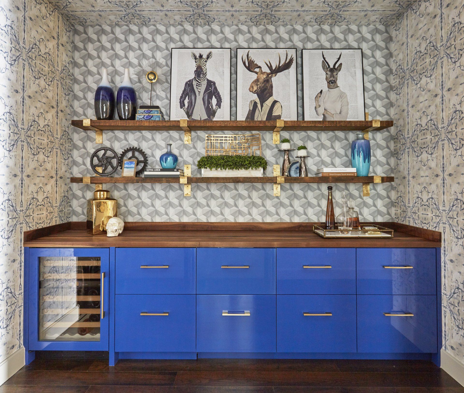 A kitchen with blue cabinets , shelves , and a wine cooler.