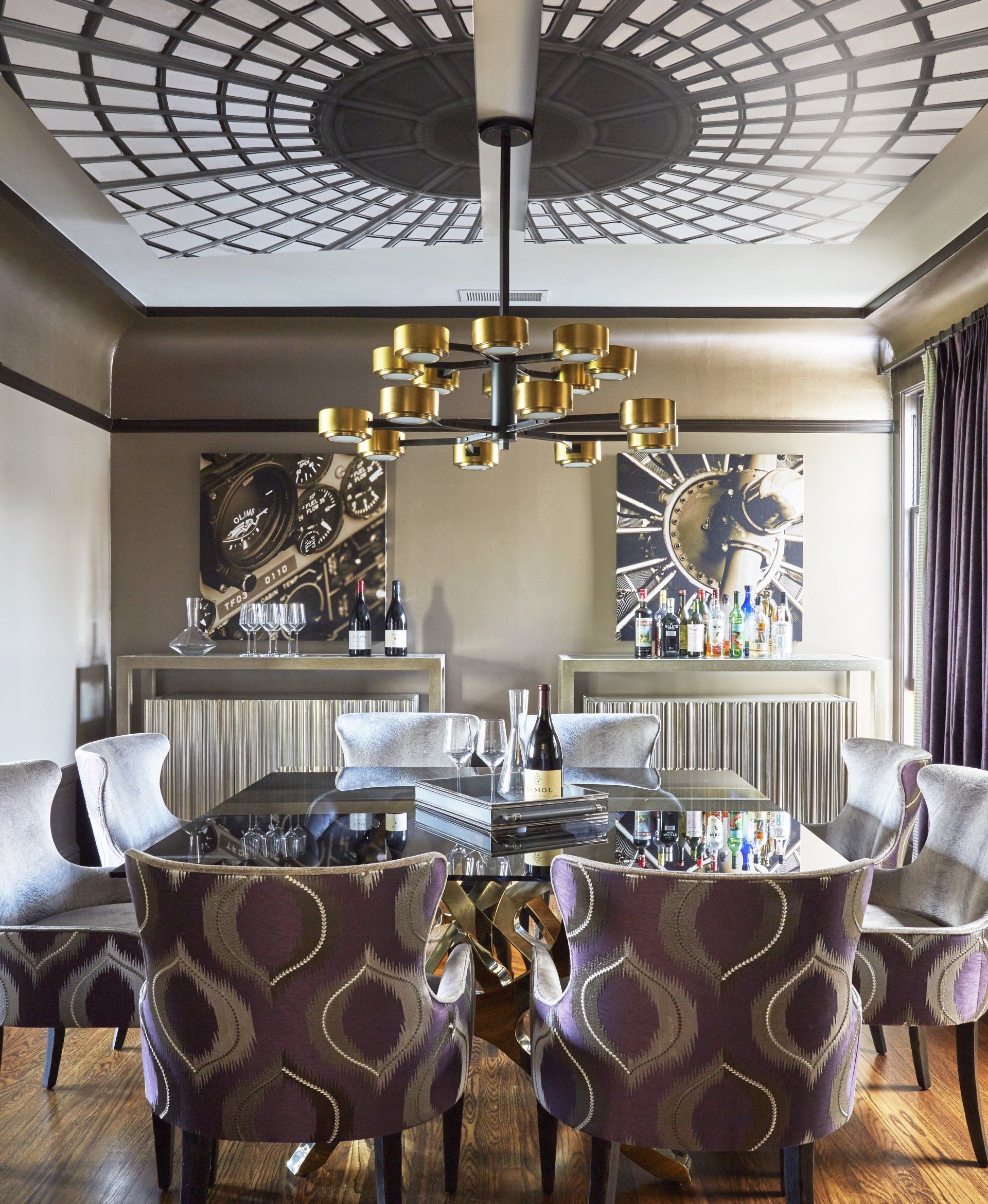 A dining room with a table and chairs and a chandelier
